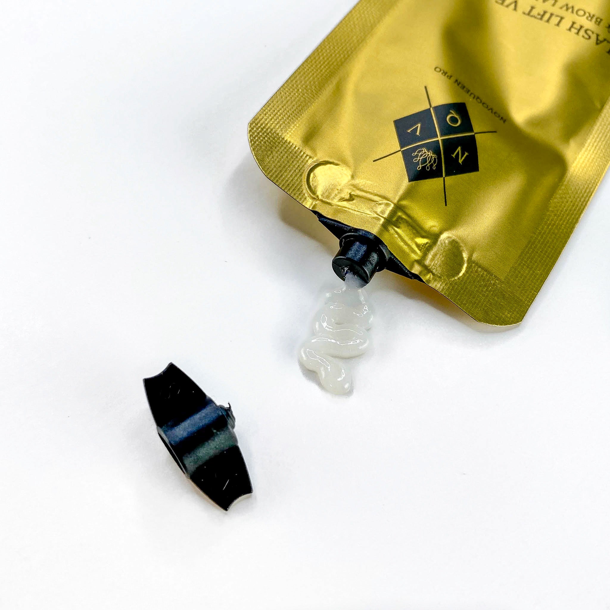 Sachet refermable dorée avec lotion de permanente pour lash lift vegan de qualité supérieure. Découvrez la texture et la consistance de la lotion qui s'écoule du sachet